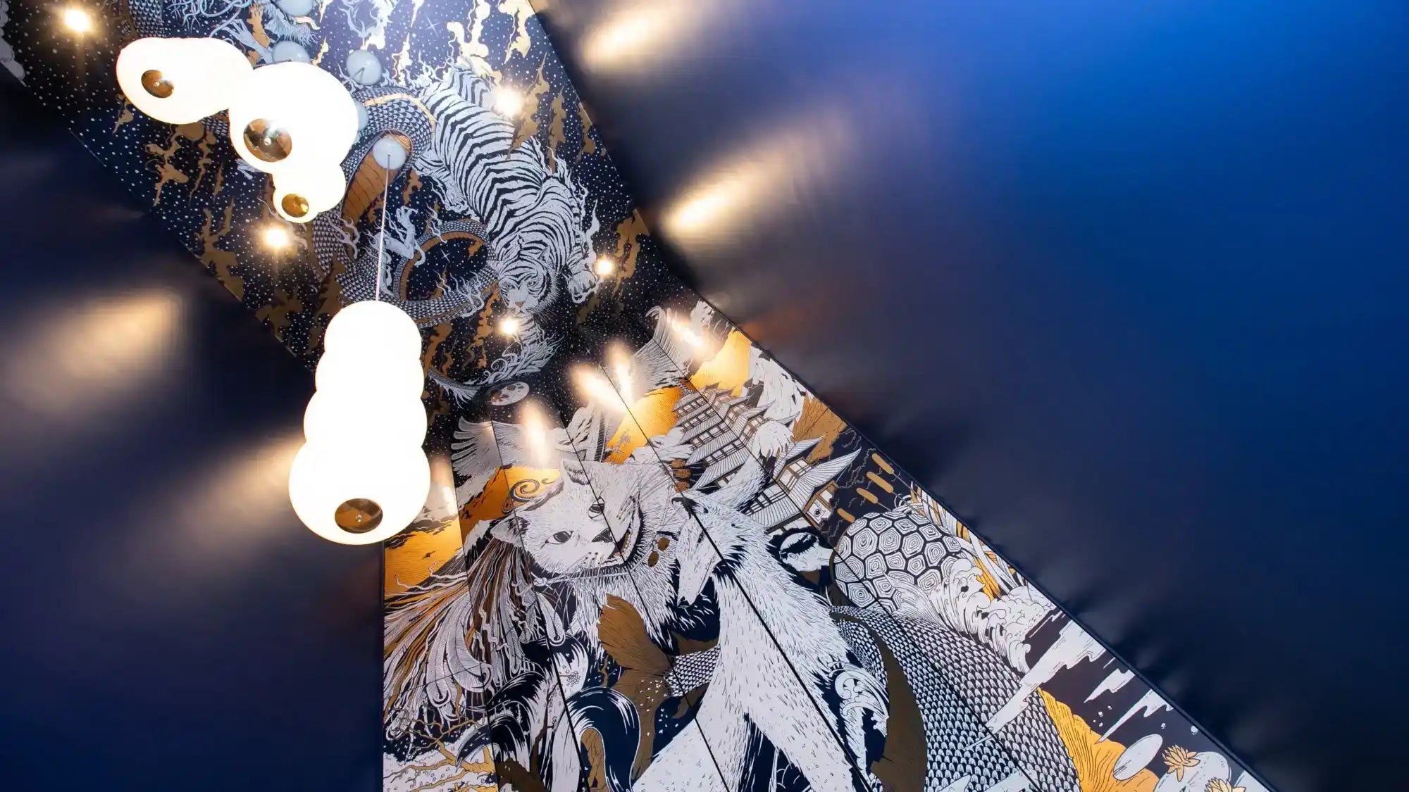 A modern, multi-tiered white and gold ceiling light fixture.